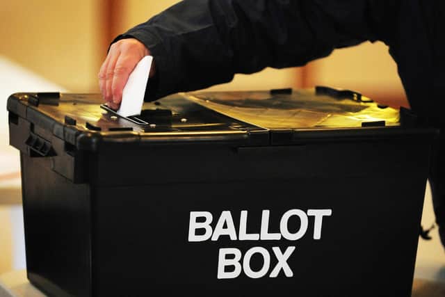 File photo dated 06/05/10 of a voter placing a ballot paper in the ballot box. More than half of people say climate change will influence the way they vote in the next general election, a survey suggests.