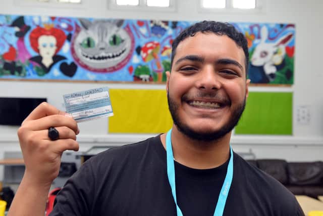 Sunderland College student Adam Shaddad, 18, proudly shows off his Covid vaccination card.