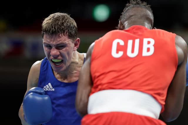TOKYO, JAPAN - JULY 31: Andy Cruz (red) of Team Cuba exchanges punches with Luke McCormack of Team Great Britain during the Men's Light (57-63kg) on day eight of the Tokyo 2020 Olympic Games at Kokugikan Arena on July 31, 2021 in Tokyo, Japan. (Photo by Ueslei Marcelino - Pool/Getty Images)
