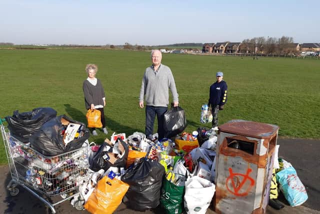 Local residents (from left to right) Diane Porter, Michael Hartnack and Susanne Kennedy collect rubbish on South Bents field.