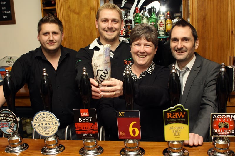 Jake Wood landlord at The White Swan is pictured with David Hemstock of Raw Brewery, Emily Evans from Ashgate Hospice and Phil Bramley of The Derbyshire Times.