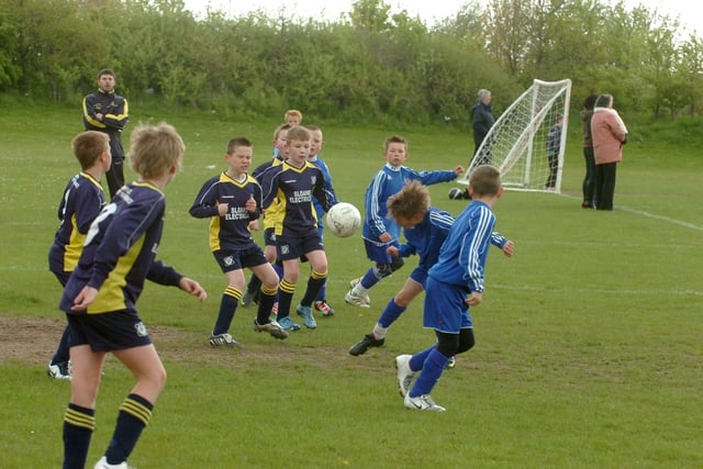 East Durham under-9s and Plains Farm (navy/yellow) get stuck in during this match.
