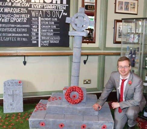 James and his sculpture dedicated to his late grandfather. Picture: James Routledge