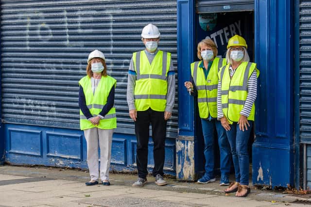 The Rev Canon David Tomlinson with members of the Murton 'Communities of Hope' project examine their planned new location in a disused shop. Photo by Keith Blundy.