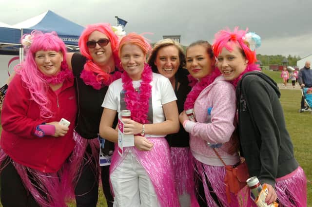 A scene from the Race for Life 10k event in 2011. It shows staff from the Sibling Nursery, at Sunderland Business and Innovation Centre, getting ready to run.