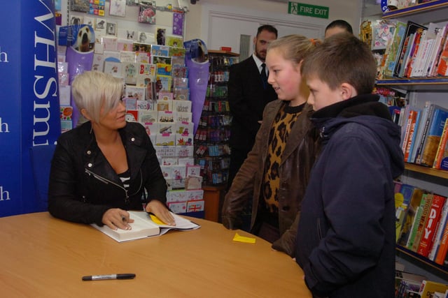 Kerry Katona signed autographs for young fans at W.H.Smith in Market Square, Sunderland in 2012. She was the winner of the third series of I'm A Celebrity.