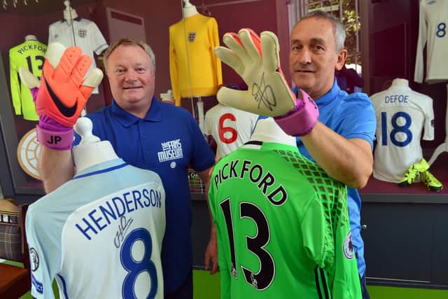 The Fans Museum's Michael Ganley and Keith Havelock with Jordan Henderson and Jordan Pickford's shirts and gloves