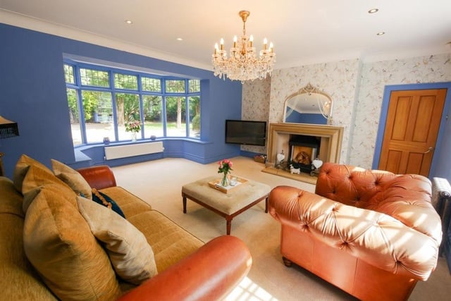 The formal living room has a large timber framed double glazed bay window and feature fireplace with open fire.
