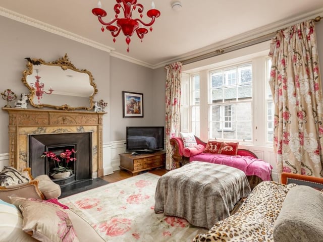 Drawing room with large windows to the street, wood flooring and an Adam fireplace.