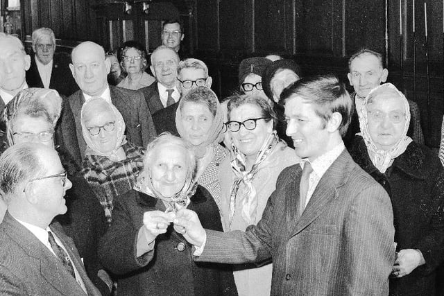 This 1974 photo shows pensioners from the Trafalgar Square Seaman's Homes being given 50 pence each in the traditional ceremony of handing out "Dame Dorothy's Dole".
It is a tradition dating back to 1699 following a bequest by Dame Dorothy Williamson upon her death to bequeath a yearly sum to charity.
