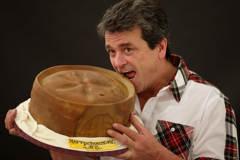 Les McKeown eating a giant birthday cake in the style of a Scotch pie as he celebrates his birthday during the World Scotch Pie Championship at the Carnegie Conference Centre in Dunfermline.