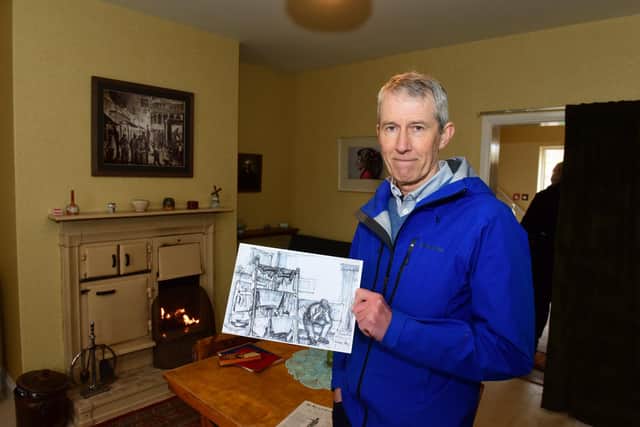 John Cornish with a sketch by his late father, the artist Norman Cornish. It features the living room of their old family home which has been recreated in the new 1950s terrace.