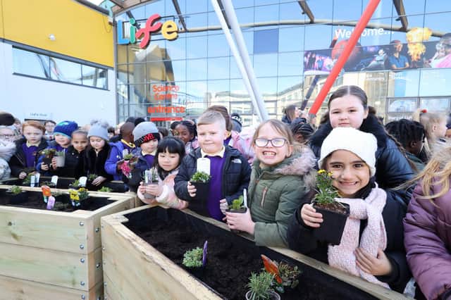 Pictured are school children and staff from Life Science Centre, Newcastle joined forces today, 10 March, to create an urban bee garden.  Pupils from Barnwell Academy, Houghton le Spring, and Central Walker Church of England Primary School, Newcastle, planted a variety of flowering shrubs in Times Square, outside the science centre, to mark the start of British Science Week - a ten-day celebration of science, technology, engineering and maths. 
The plants were specially selected by the Life team to ensure they bloom and provide food for bees throughout the year. Ben Rutherford-Orrock from Life said: “Almost 90% of wild plants and 75% of global crops depend on animal pollination* and the wild bee population is in decline. Even in the heart of the city, whether it’s here in Times Square, in a school yard or in a window box at home, we can all do our bit to encourage and nurture the wild bee population. The snowy weather we’re experiencing at the moment means it’s even more important to have food that’s high in pollen and nectar, readily available for bees. Spring bulbs like snowdrops and crocus are perfect for this as they flower early.”  
See copy by North News