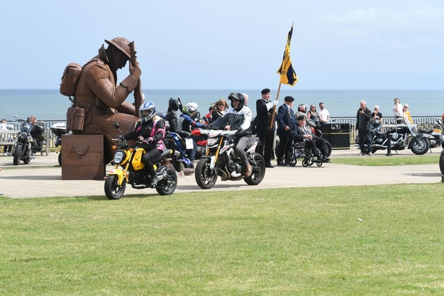 Bikers pass by Ray Lonsdale's Tommy Statue at Terrace Green.