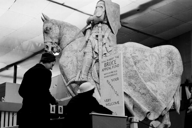 Children marking donations at the Robert the Bruce statue at the 'This Scotland' Exhibition at Waverley Market in August 1963.