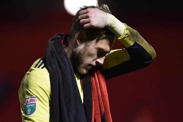 Paul Woolston of Manchester United U21's looks dejected after the EFL Trophy match between Accrington Stanley and Manchester United U21` at The Crown Ground on December 08, 2020 in Accrington, England. (Photo by Nathan Stirk/Getty Images)