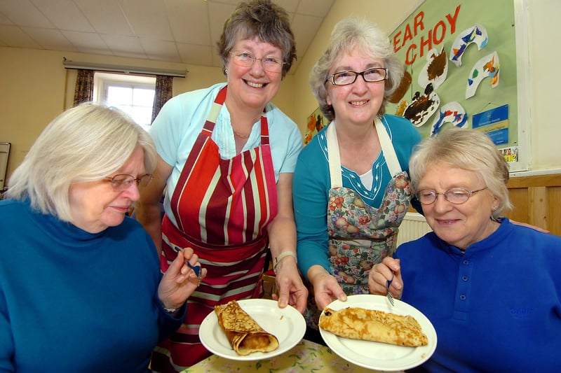Ann Gray (stood, left) and Eunice Randall serve up pancakes to Janet Hughes (left) and Glenise Sinnott, of Warmsworth, at the Methodist Church Hall in Tickhill in 2010
