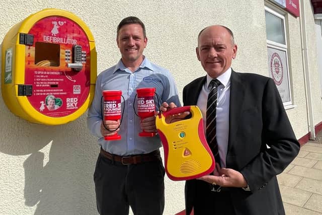 Chris Burnicle and John Hogg with the second defibrillator in memory of Christine Graham