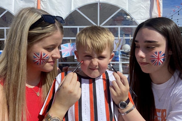 Alfie Mullen has his face painted by Robyn Head (left) and Jessica Houghton during the Queens Jubilee celebrations at Seaham Cricket Club.
