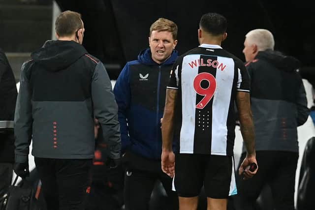 Newcastle United's English head coach Eddie Howe (2nd L) speaks with Newcastle United's English striker Callum Wilson as he leaves the game injured during the English Premier League football match between Newcastle United and Manchester United at St James' Park in Newcastle-upon-Tyne, north east England on December 27, 2021. (Photo by PAUL ELLIS/AFP via Getty Images)