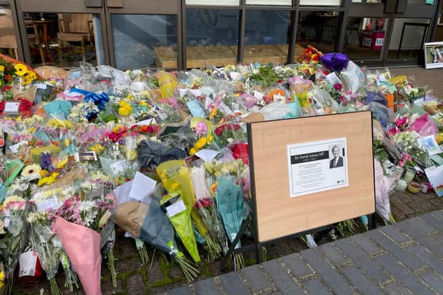 A sign placed next to the floral tributes left outside the Belfairs Methodist Church in Leigh-on-Sea, Essex, where Conservative MP Sir David Amess was killed on Friday, October 15. Picture: PA.