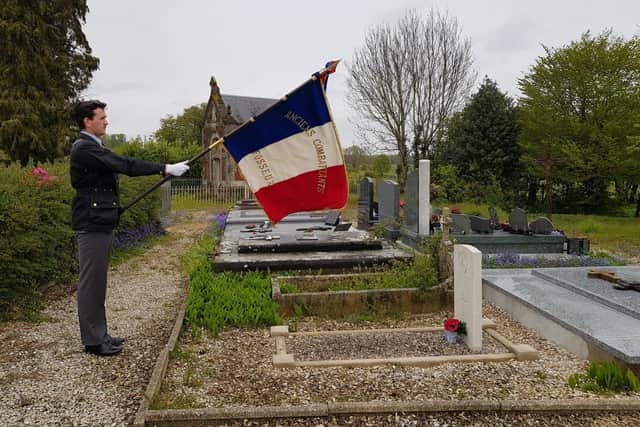 The flag bearer at the graveside of Private Thomson.