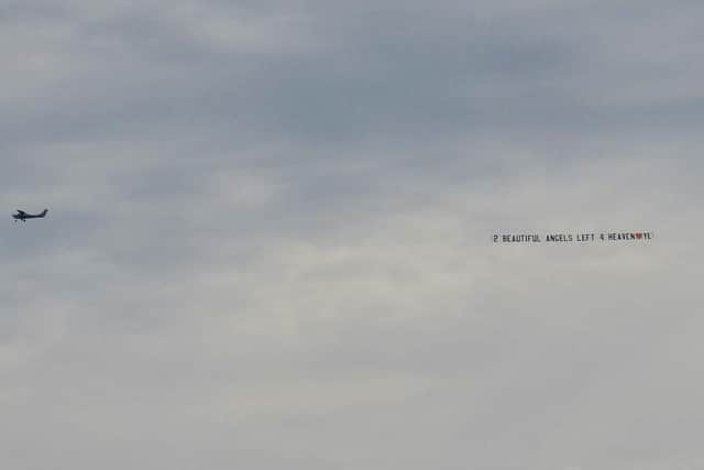 A plane flew overhead, carrying a message in tribute to the girls.