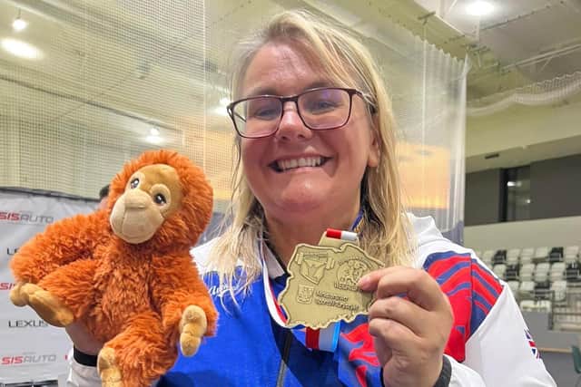 Zoe Chandler and friend show off her weightlifting gold medal at the European Masters in Poland.