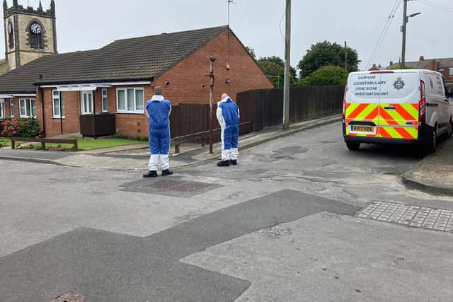 Forensic officers pictured in the street on Wednesday.