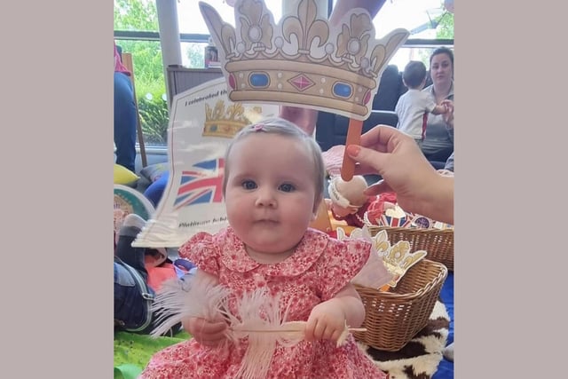 Emmie Whittle, age 9 months, tries on her very own crown.