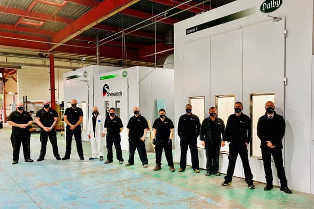 Sherwoods’ Bodyshop manager Marc Madden with his team in front of the new spray booths.