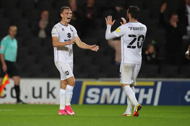 MILTON KEYNES, ENGLAND - SEPTEMBER 28: Scott Twine of Milton Keynes Dons  celebrates with Troy Parrott after scoring his and his sides second goal during the Sky Bet League One match between Milton Keynes Dons and Fleetwood Town at Stadium mk on September 28, 2021 in Milton Keynes, England. (Photo by Pete Norton/Getty Images)