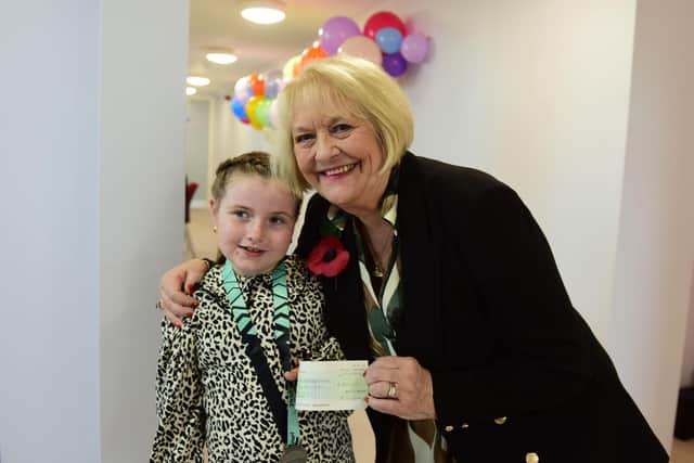 Seven year-old Anya Amer presented a cheque for the £250 she raised by completing the Junior Great North Run. With charity founder Sandra Falkner. Picture by Kevin Brady.