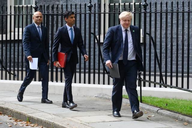 Chancellor Rishi Sunak (centre) and Prime Minister Boris Johnson (right) with Health Secretary Sajid Javid