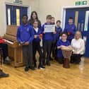 (left to right) Elizabeth Paget, Emma Mapplebeck and Laura Parkin celebrating their Music Mark award with pupils from St Mary’s Catholic Primary School..