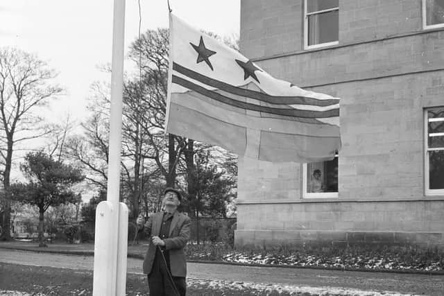 Washington's new town flag is raised in 1965.