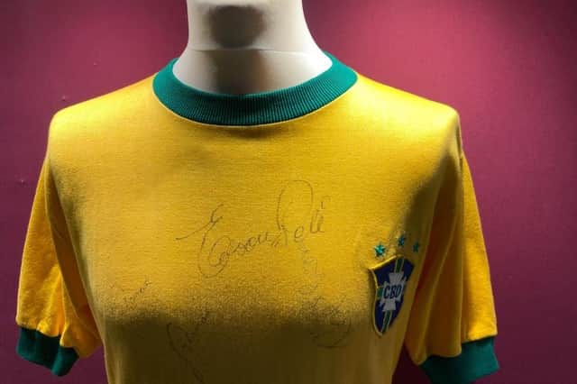 The shirt is signed by Pele and other members of the Brazil World Cup squad