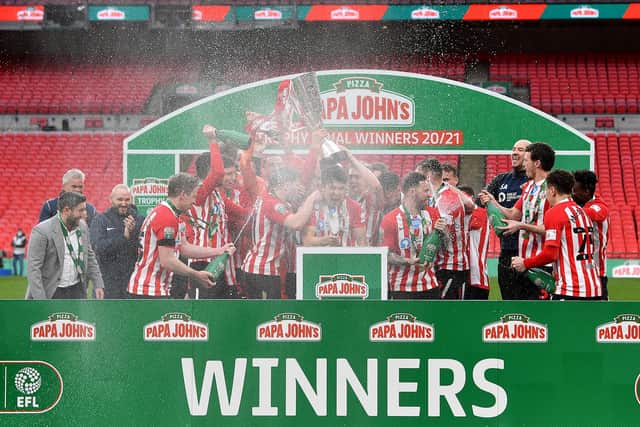 Sunderland players celebrate with the Papa John's Trophy after the Papa John's Trophy Final match between Sunderland and Tranmere Rovers on March 14, 2021.