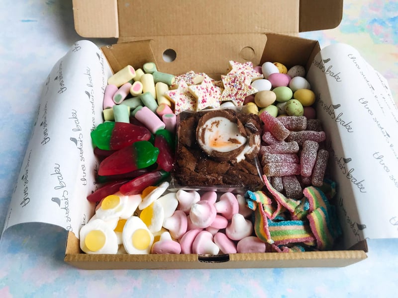 The Easter Sweetie Treat Box from Three Sisters Bake in Glasgow and Quarriers Village contains a Mini Egg cookie slice or Creme Egg brownie, each surrounded by a sweet shop's worth of sugary stuff. Order on their website. 
www.threesistersbake.co.uk