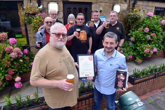 Ian Montieth-Preston of CAMRA presents Martin Thompson of The Courtyard Cafe Bar at Arts Centre Washington with a certificate marking 20 successive years in the Good Pub Guide. Sunderland Echo image.