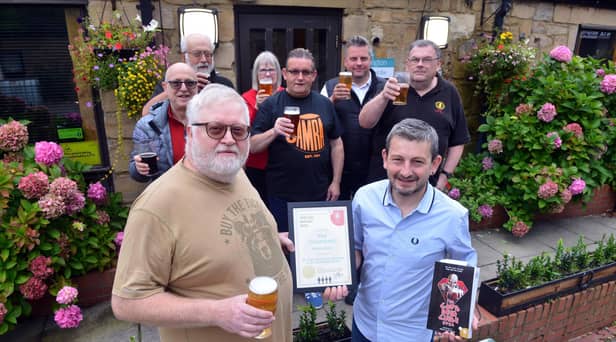 Ian Montieth-Preston of CAMRA presents Martin Thompson of The Courtyard Cafe Bar at Arts Centre Washington with a certificate marking 20 successive years in the Good Pub Guide. Sunderland Echo image.
