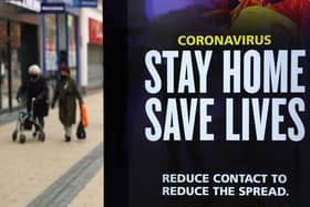 People walk past a 'Stay Home Save Lives' sign on Broadmead in Bristol during England's third national lockdown to curb the spread of coronavirus. Under increased measures people can no longer leave their home without a reasonable excuse and schools must shut for most pupils. PA Photo. Picture date: Saturday January 9, 2021. See PA story HEALTH Coronavirus. Photo credit should read: Andrew Matthews/PA Wire