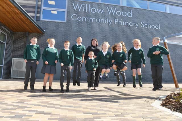 Willow Wood Community Primary School headteacher Lindsay Robertson and her pupils jump for joy at good Ofsted judgement.