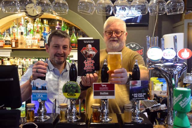 Ian Montieth-Preston of CAMRA (right) with Martin Thompson of The Courtyard Cafe Bar at Arts Centre Washington, celebrating the pub's 20 successive years in the Good Pub Guide. Sunderland Echo image.