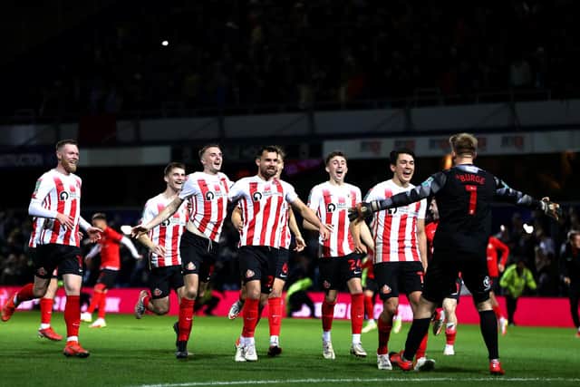 LONDON, ENGLAND - OCTOBER 26: Players of Sunderland congratulate goalkeeper Lee Burge of Sunderland following his performance during the penalty shoot out in the Carabao Cup Round of 16 match between Queens Park Rangers and Sunderland at Loftus Road on October 26, 2021 in London, England. (Photo by Ryan Pierse/Getty Images)