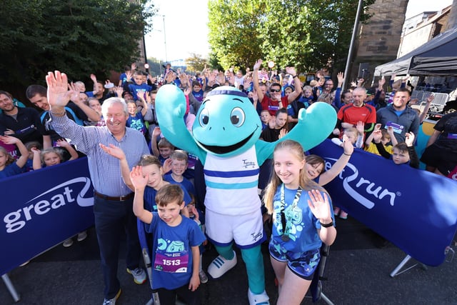 Great North Run founder Brendan Foster with Elizabeth Schulz, 11, who designed mascot Tyney.