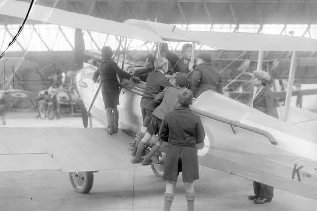 Excited schoolboys get to see a Tiger Moth close up at RAF Usworth on Empire Day in May 1939.