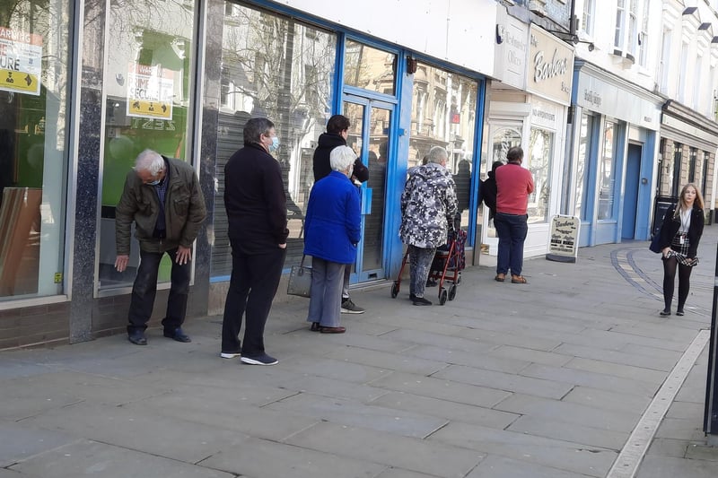 Another queue for the barber's shop in High Street.