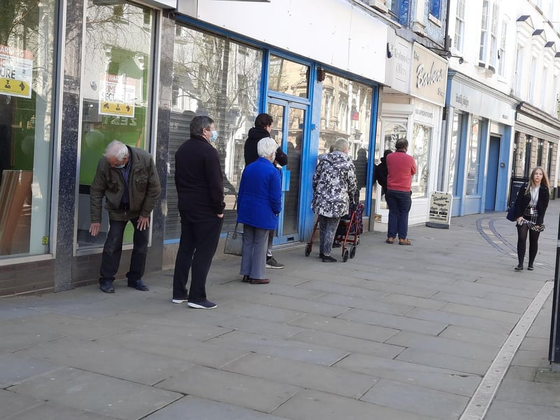 Another queue for the barber's shop in High Street.
