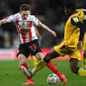 SUNDERLAND, ENGLAND - JANUARY 11: Denver Hume of Sunderland in action during the Sky Bet League One match between Sunderland and Lincoln City at Stadium of Light on January 11, 2022 in Sunderland, England. (Photo by Stu Forster/Getty Images)
